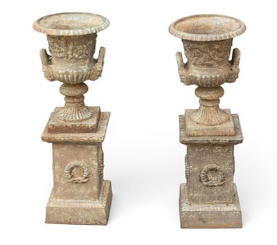 Pair of Cast Iron Urns on Bases. Pair of cast iron urns with flared rims, twin handles, and 
