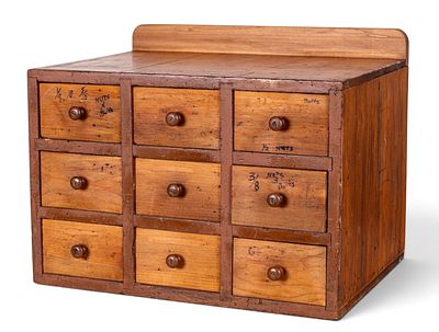 Wooden Multi-Drawer Cabinet. Wooden cabinet with nine small drawers, featuring round wooden 