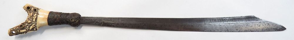Lot 230: A DAYAK HEADHUNTER MANDAU SWORD