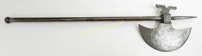 A NORTH INDIAN BATTLEAXE. The crescent-form steel head, dragon form back spike, haft and 