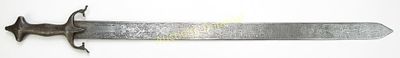A PERSIAN BROADSWORD. Wrought entirely of steel, the steel hilt with symmetrical lobed pommel 