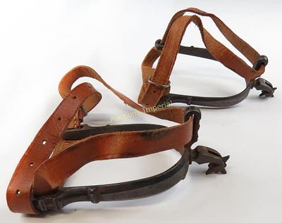 A PAIR OF MEXICAN SPURS. Wrought of steel with faceted arms and profiled terminals, the necks 