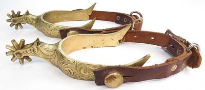 A PAIR OF WESTERN SPURS. Wrought of brass and engraved and overall, with spiked rowels and 