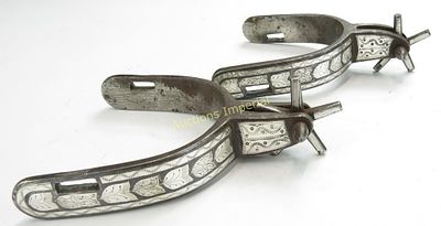 A PAIR OF AMERICAN WESTERN SPURS. Each wrought of steel and inlaid with figured and engraved 