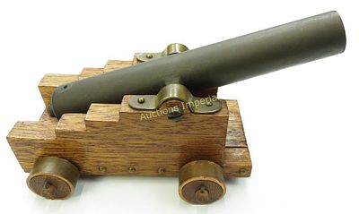 A BLACK POWDER MODEL NAVAL CANNON. With heavy bronze tube, on its hardwood carriage with brass 