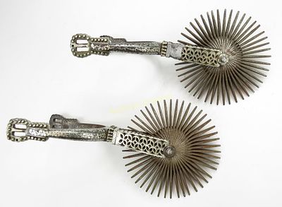 A PAIR OF CHILEAN HUASO SPURS. Finely wrought in steel with characteristic large rowels, the 