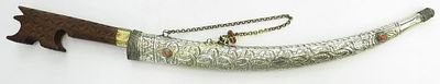 AN ALGERIAN NIMCHA DAGGER. An unusually fine example, with characteristic scrolled and hooked 