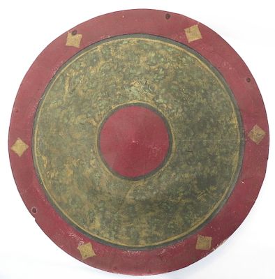 A RARE BHUTANESE CHAM PROCESSION SHIELD. Of circular form, lacquered canvas with red, green and 