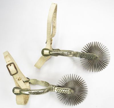 A PAIR OF CHILEAN HUASO SPURS. Well-made, with characteristic large rowels. Leathers intact. 