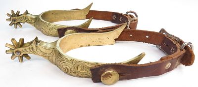 A PAIR OF WESTERN SPURS. Wrought of brass and engraved and overall, with spiked rowels and 