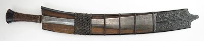 A KACHIN NAGA HEADHUNTER DAO. Kachin work, the wooden hilt with rattan-wrapped grip. The 
