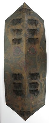 A RARE DAYAK KLIAU SHIELD. Of characteristic form, carved from a single large section of wood 