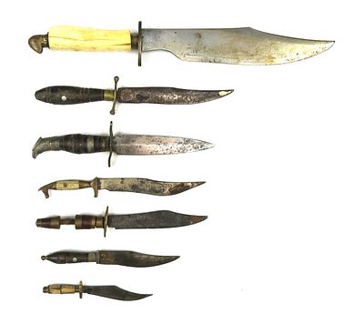 SEVEN (7) MEXICAN BOWIE-TYPE KNIVES. Ranging in size from large to small, with organic grips and 