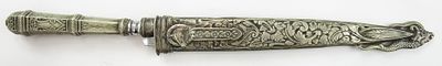 AN ARGENTINE GAUCHO KNIFE. The white metal mounts embellished with piercing and engraving, the 