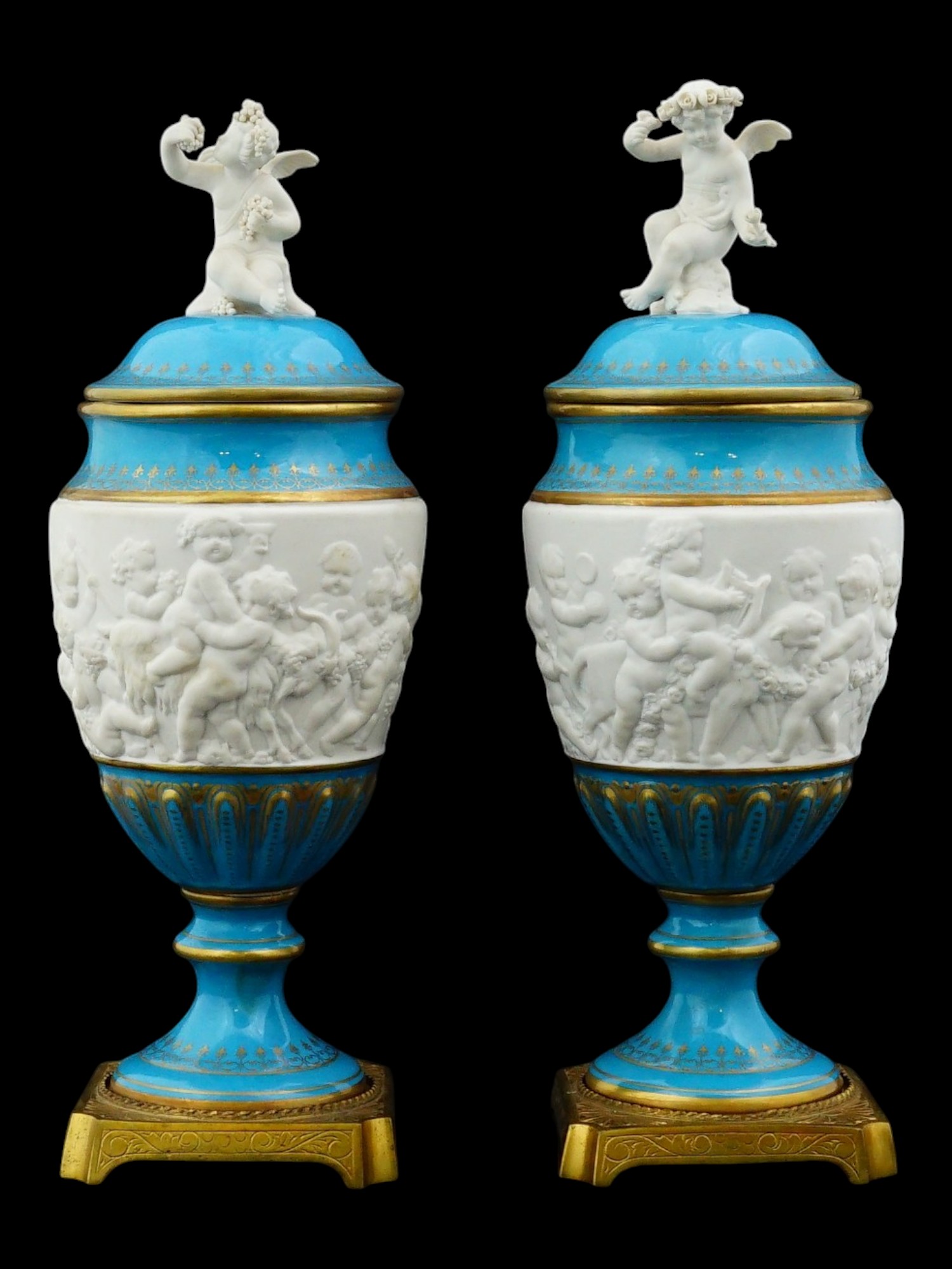 PAIR OF SEVRES STYLE BISCUIT PORCELAIN LIDDED URNS