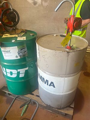 *. New half barrel of Fendt transmission fluid. Used barrel of oil. Quarter full