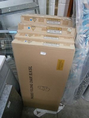 Seven boxed padded folding chairs