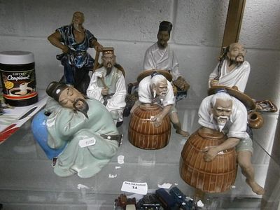 Seven assorted oriental Mudman figurines
