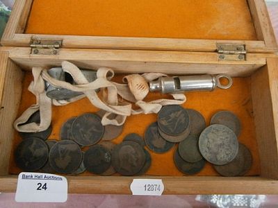 Old wooden box containing coins and whistles