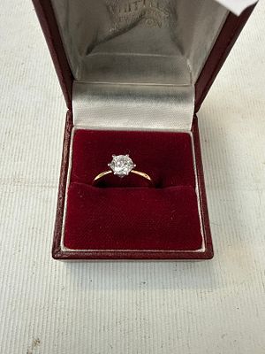 Gold coloured ring with white stone