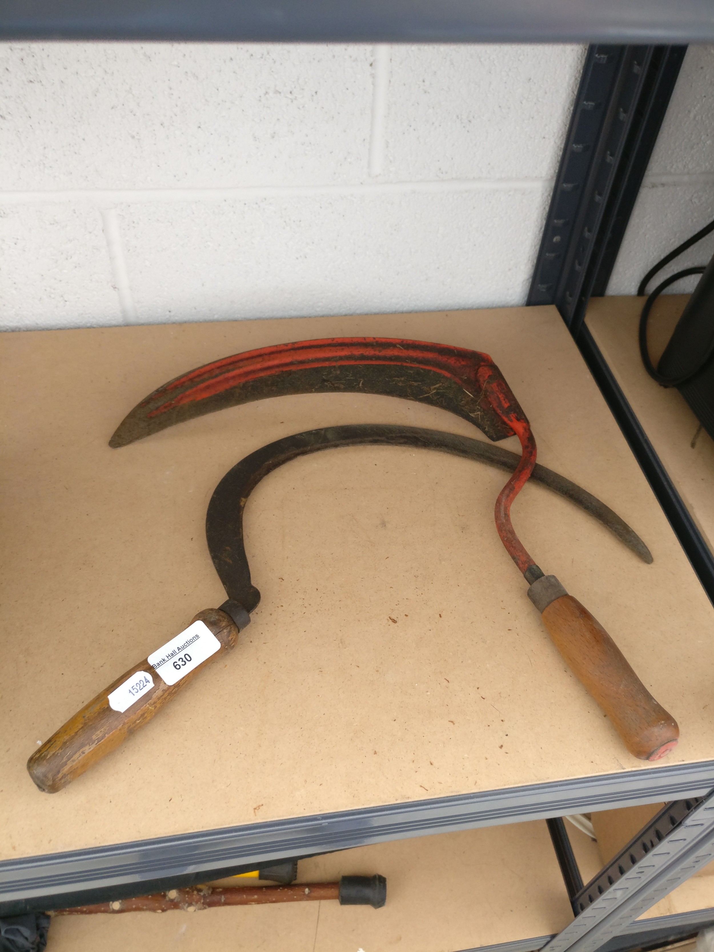 Two grass scythes