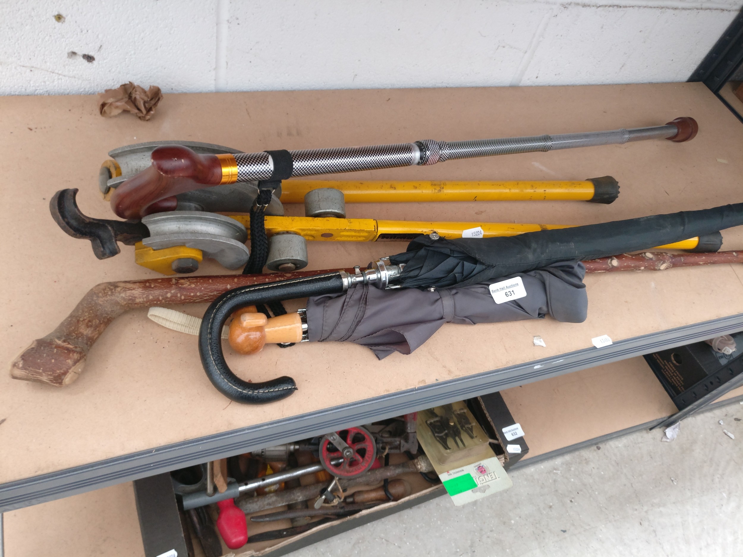 Lot inc walking stick, umbrellas and pipe bender
