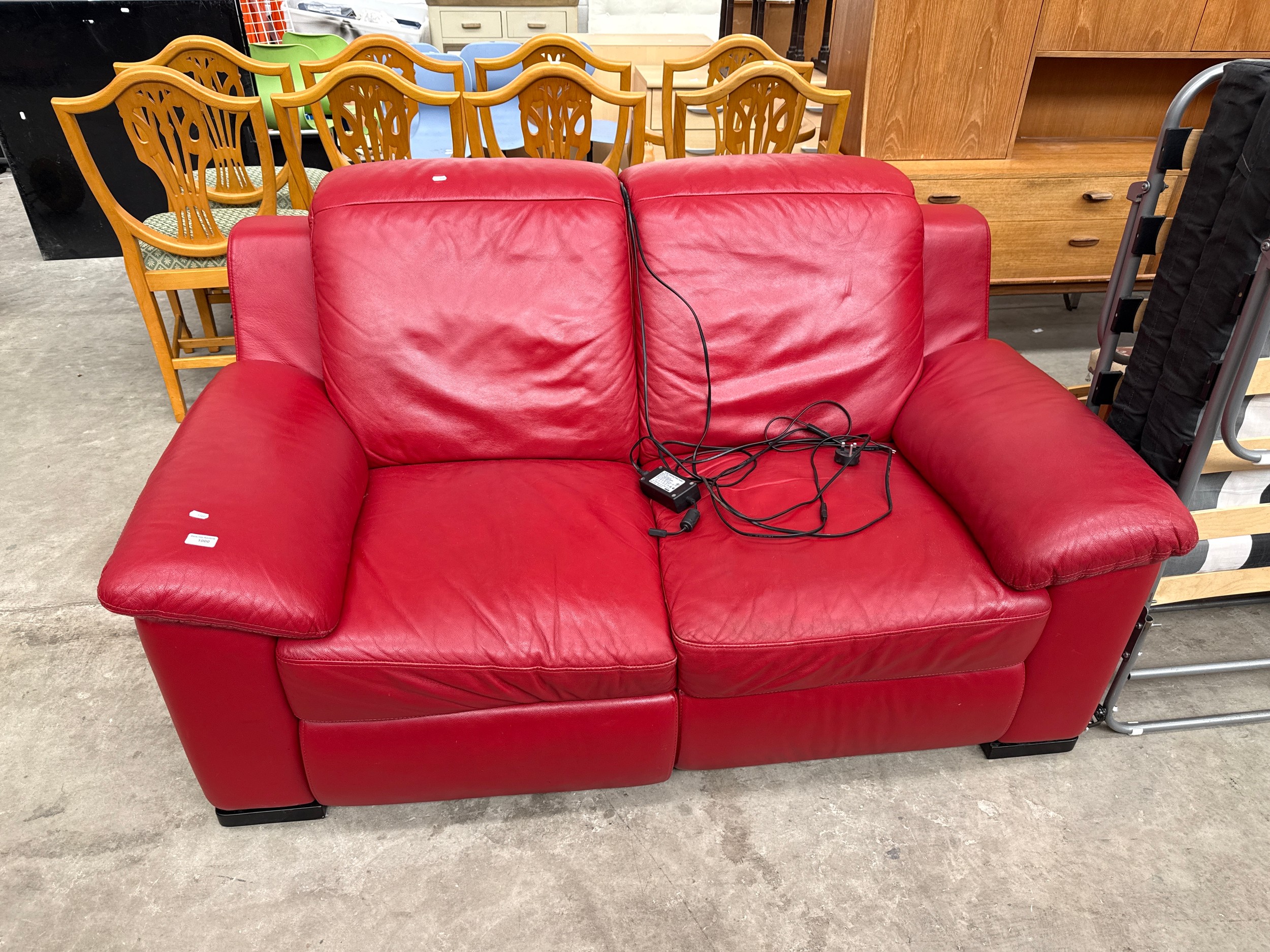 A padded red leather 2 seater electric recliner settee on side not reclining