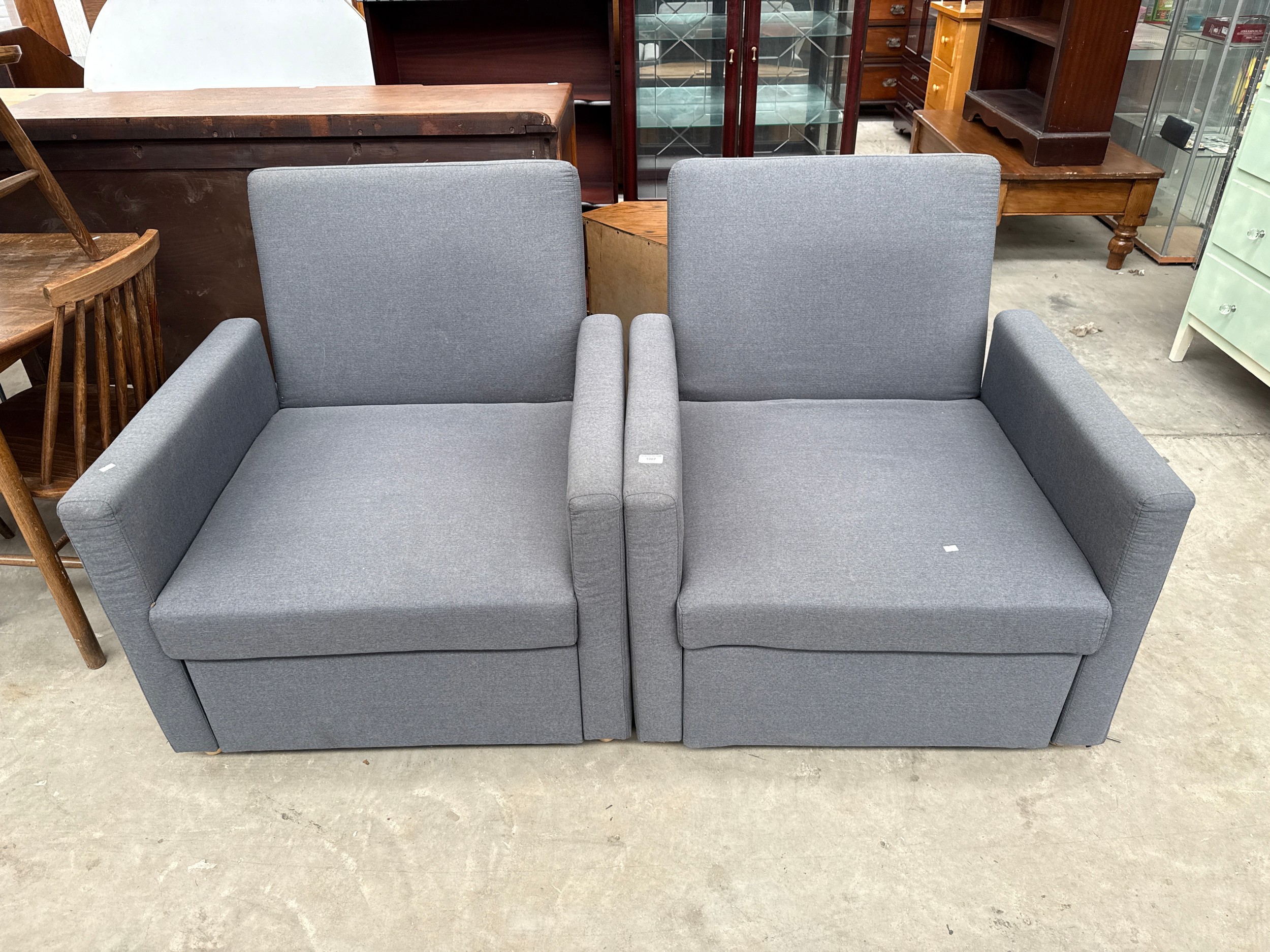 A pair of upholstered Club style armchairs