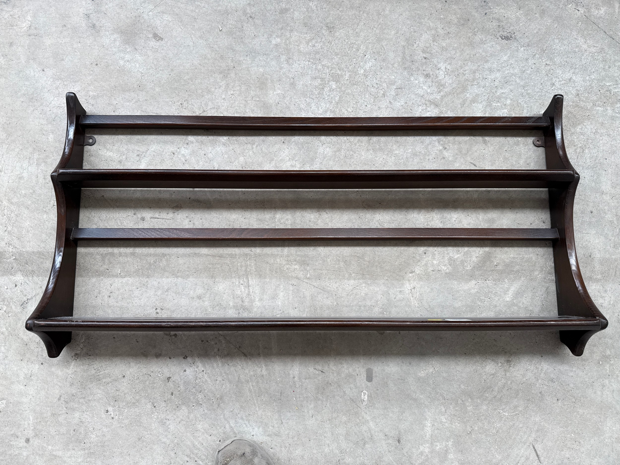 A vintage dark ERCOL wall mounted plate rack