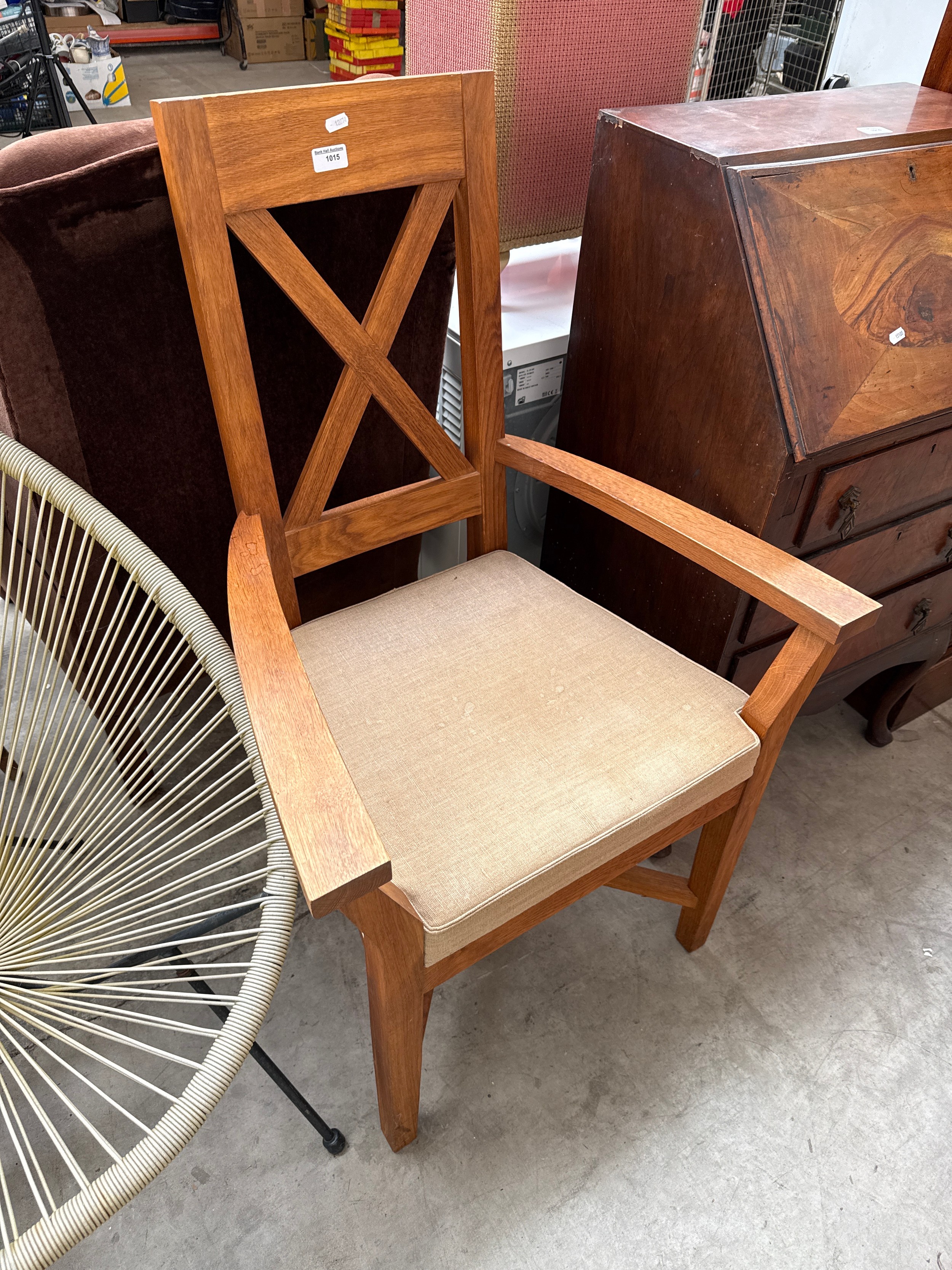 A modern solid oak chair with upholstered seat