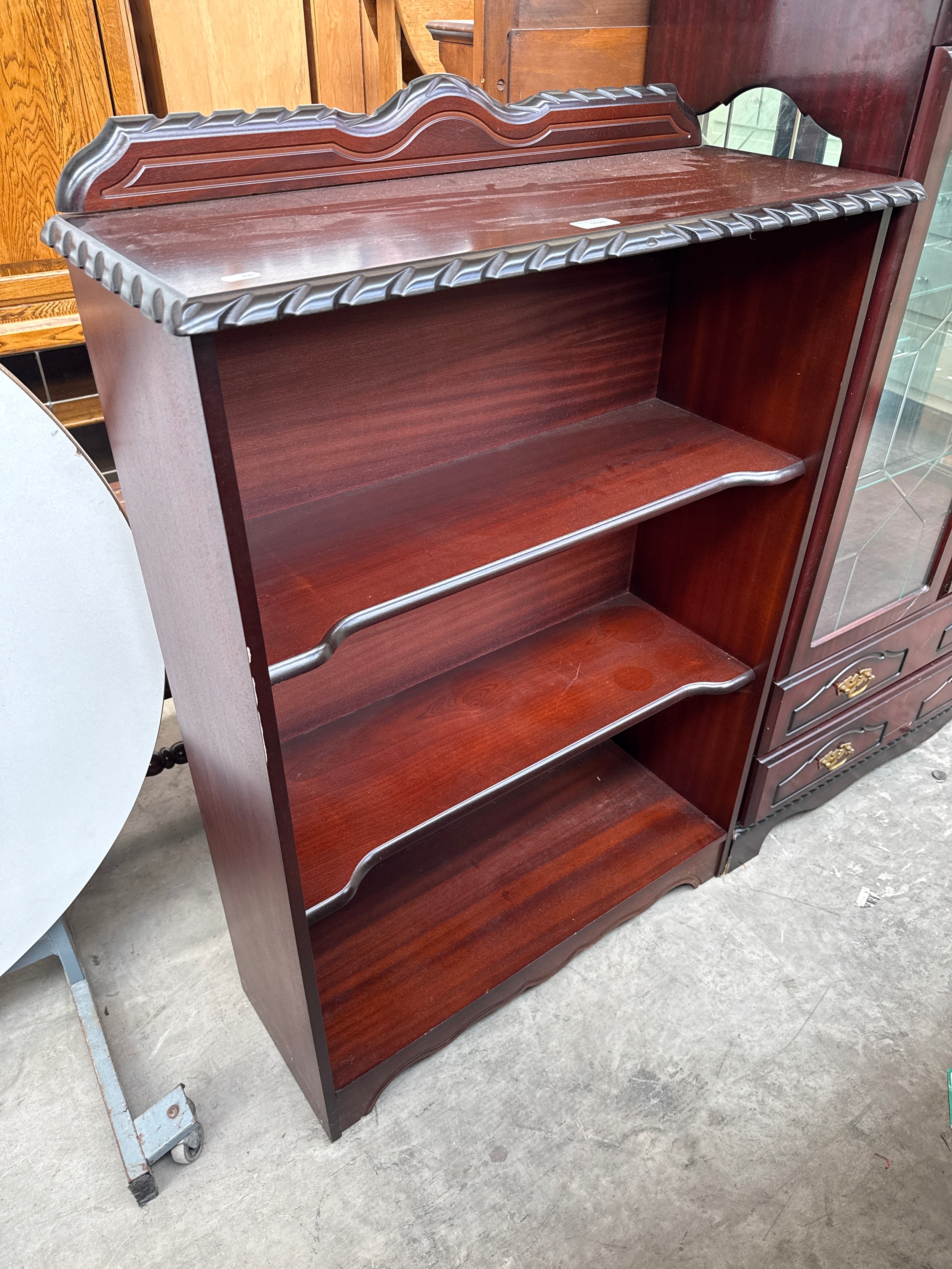 A vintage mahogany open bookcase with rope twist decoration