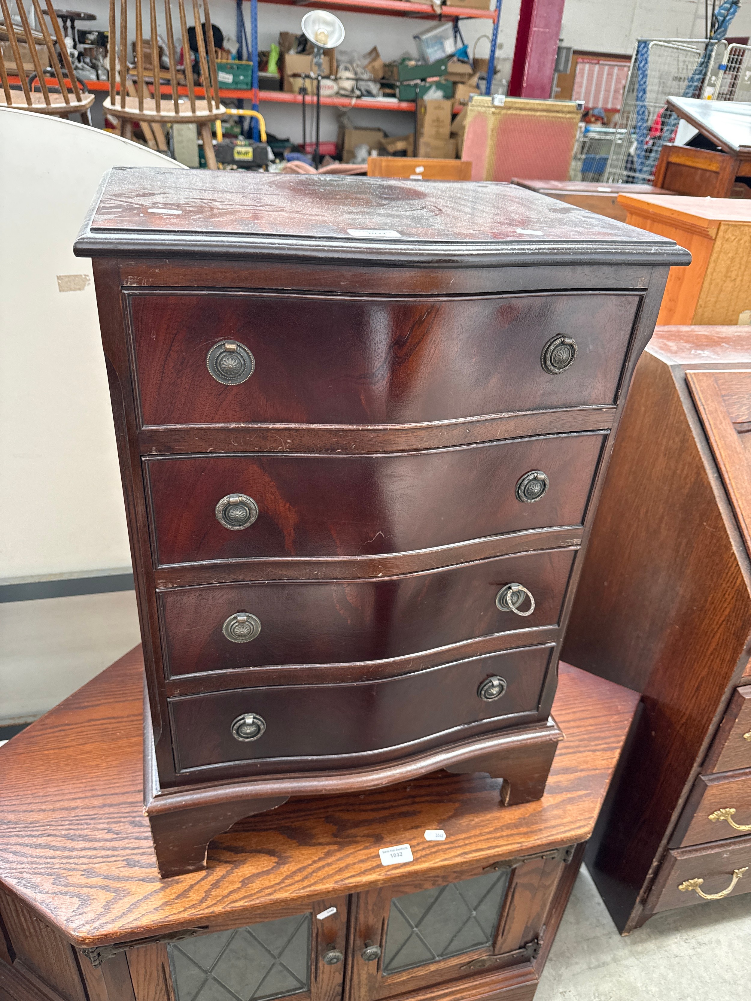 A small vintage serpentine fronted 4 drawer mahogany chest