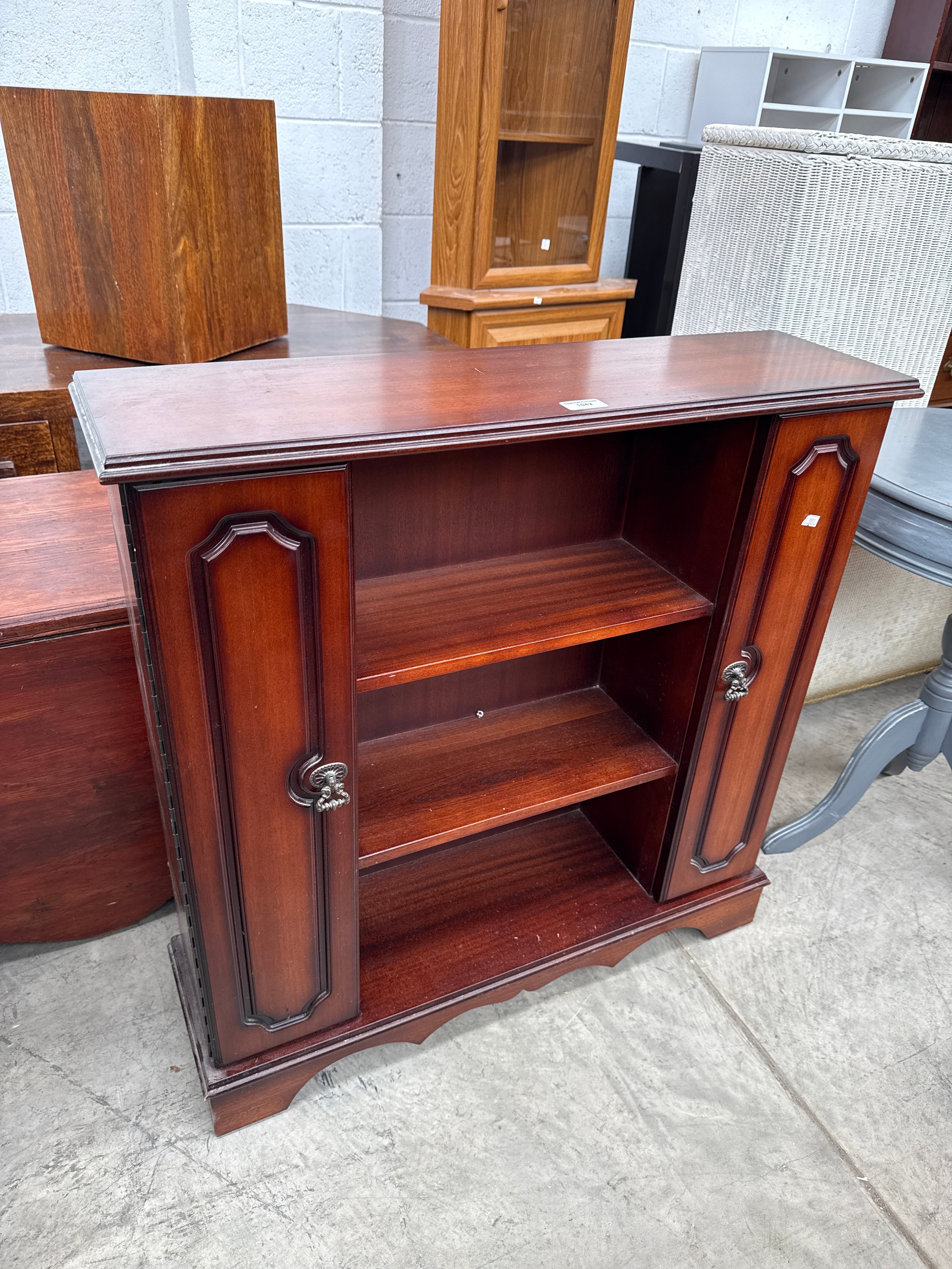 A small vintage mahogany disc storage unit
