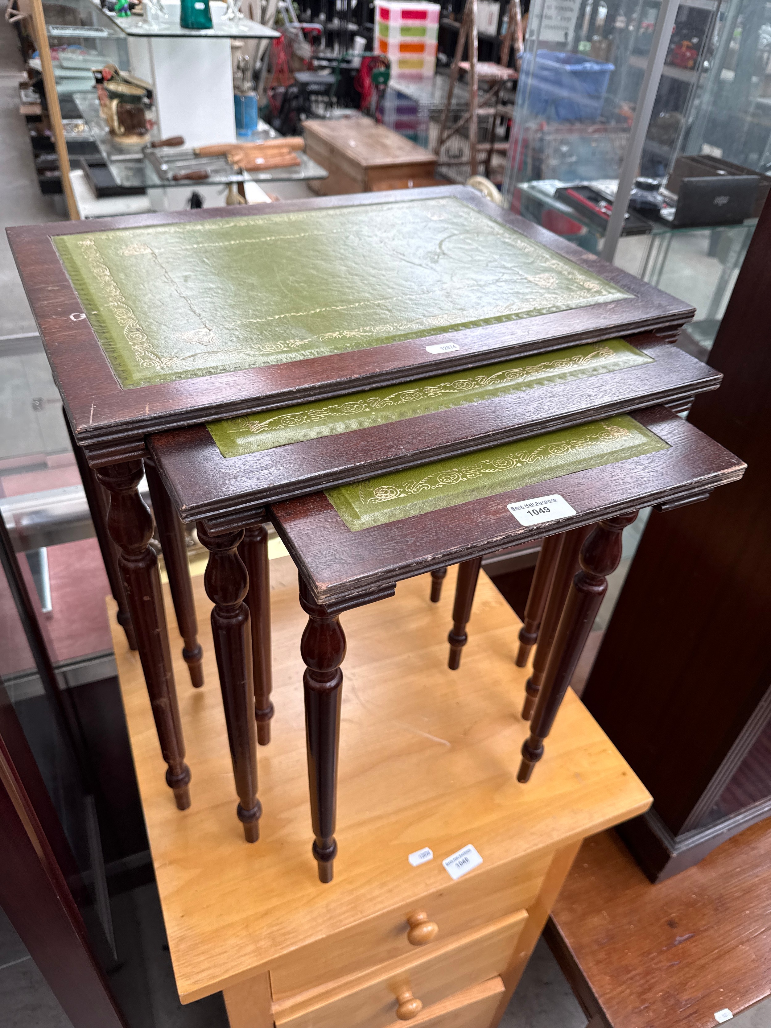 A nest of 3 x vintage leather topped occasional tables