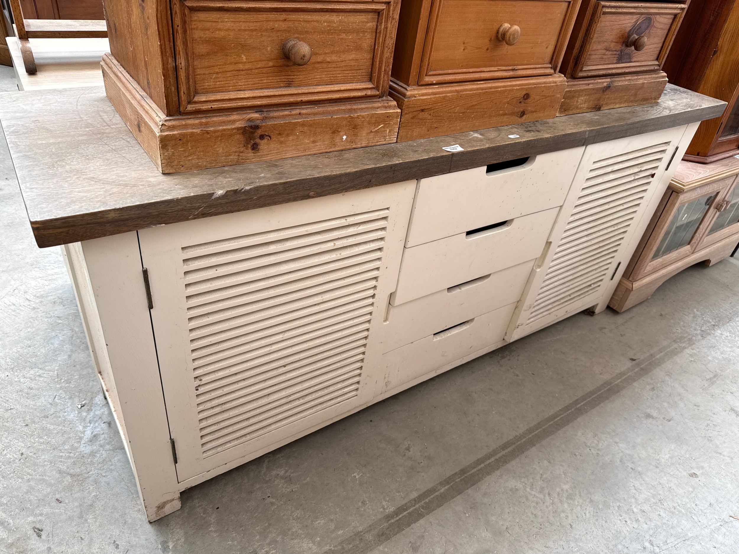 A large vintage base unit with solid wooden top and painted 4 drawer base