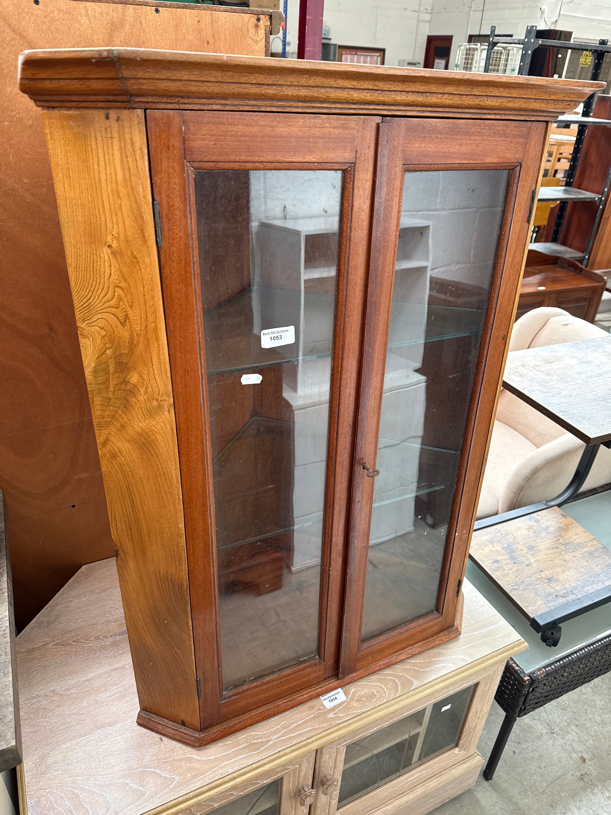 A vintage wall hanging glazed corner cabinet