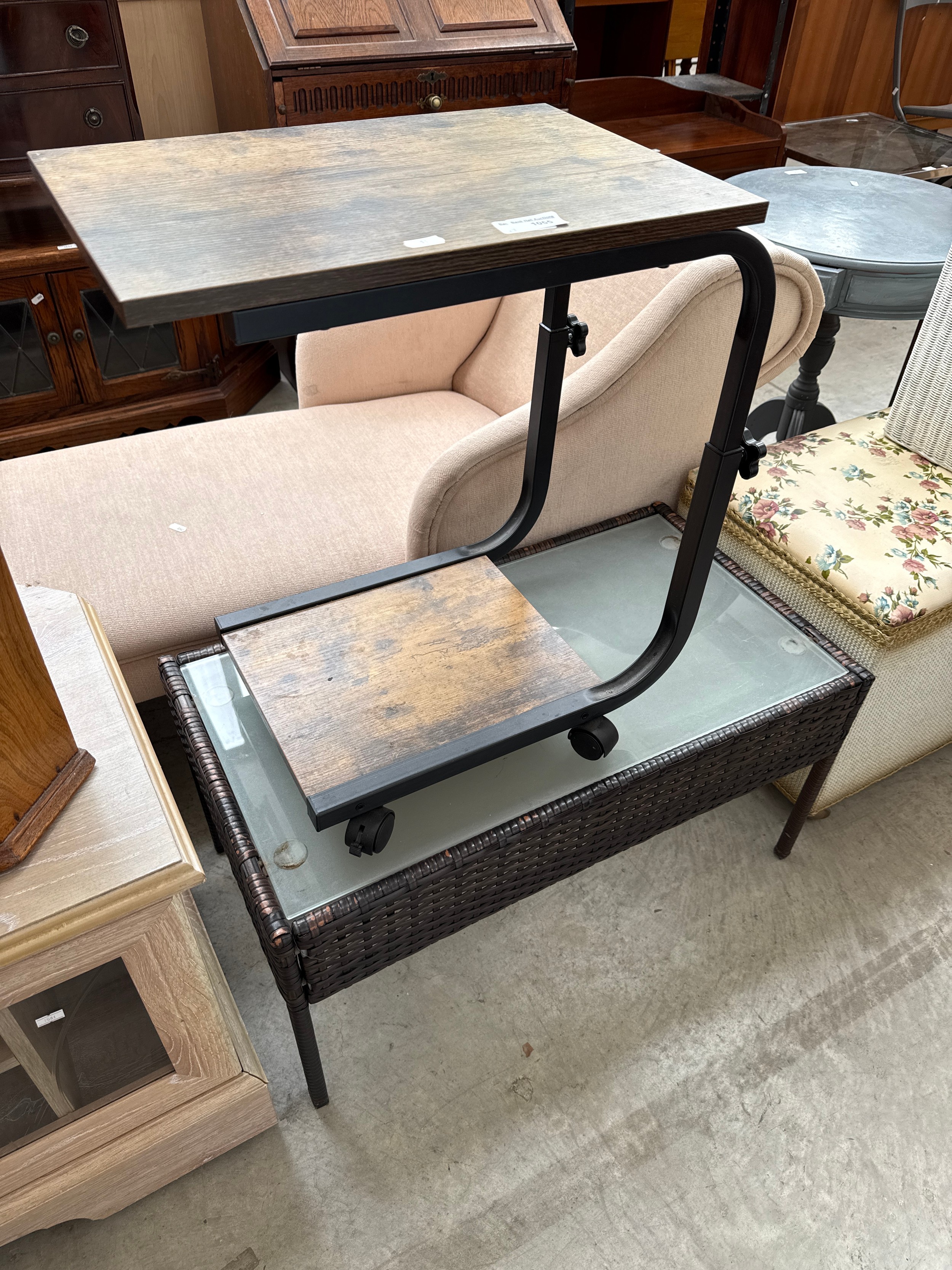 A small glass topped coffee table and a trolley table