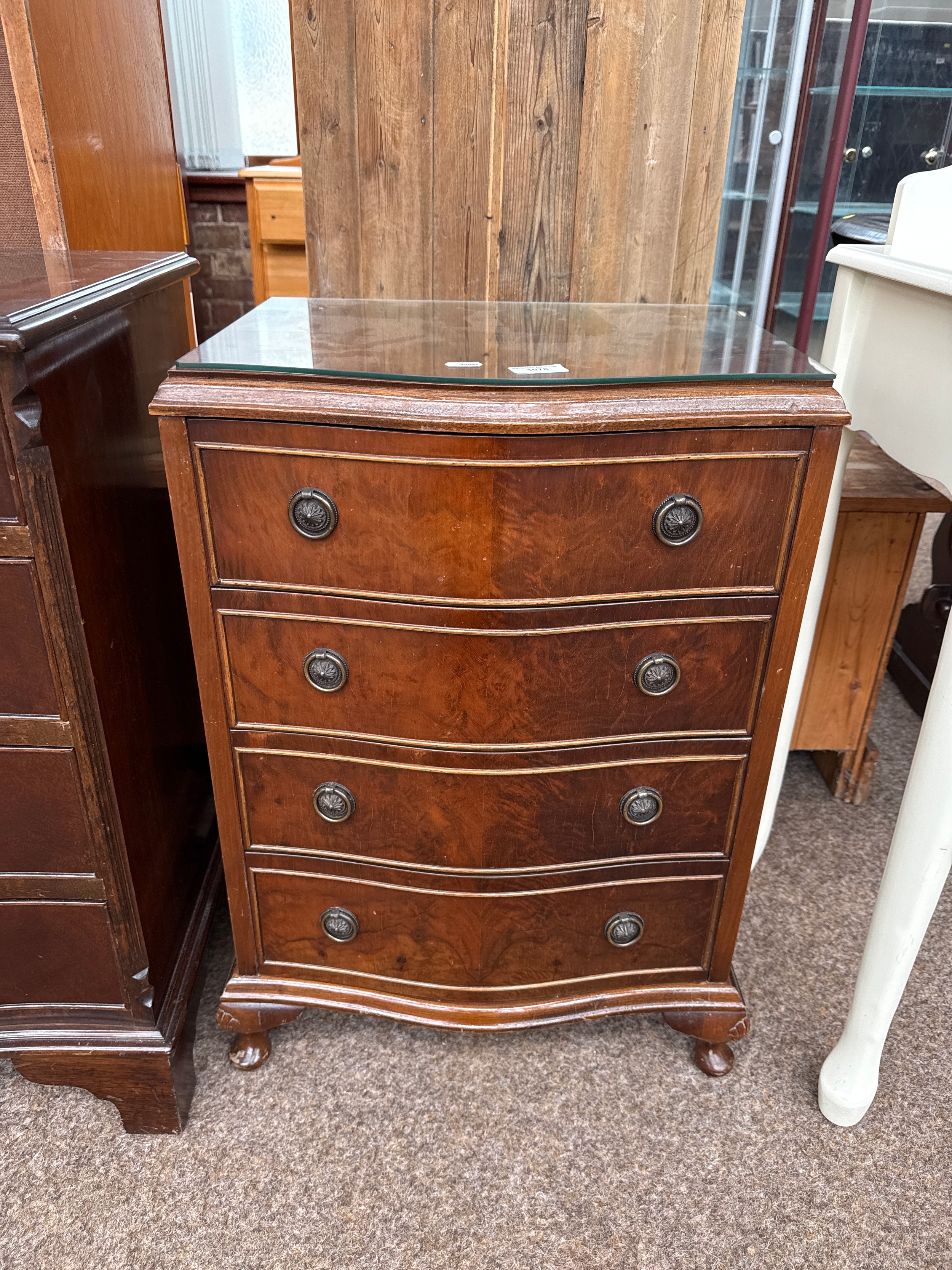 A small vintage serpentine fronted 4 drawer chest with shell carved legs