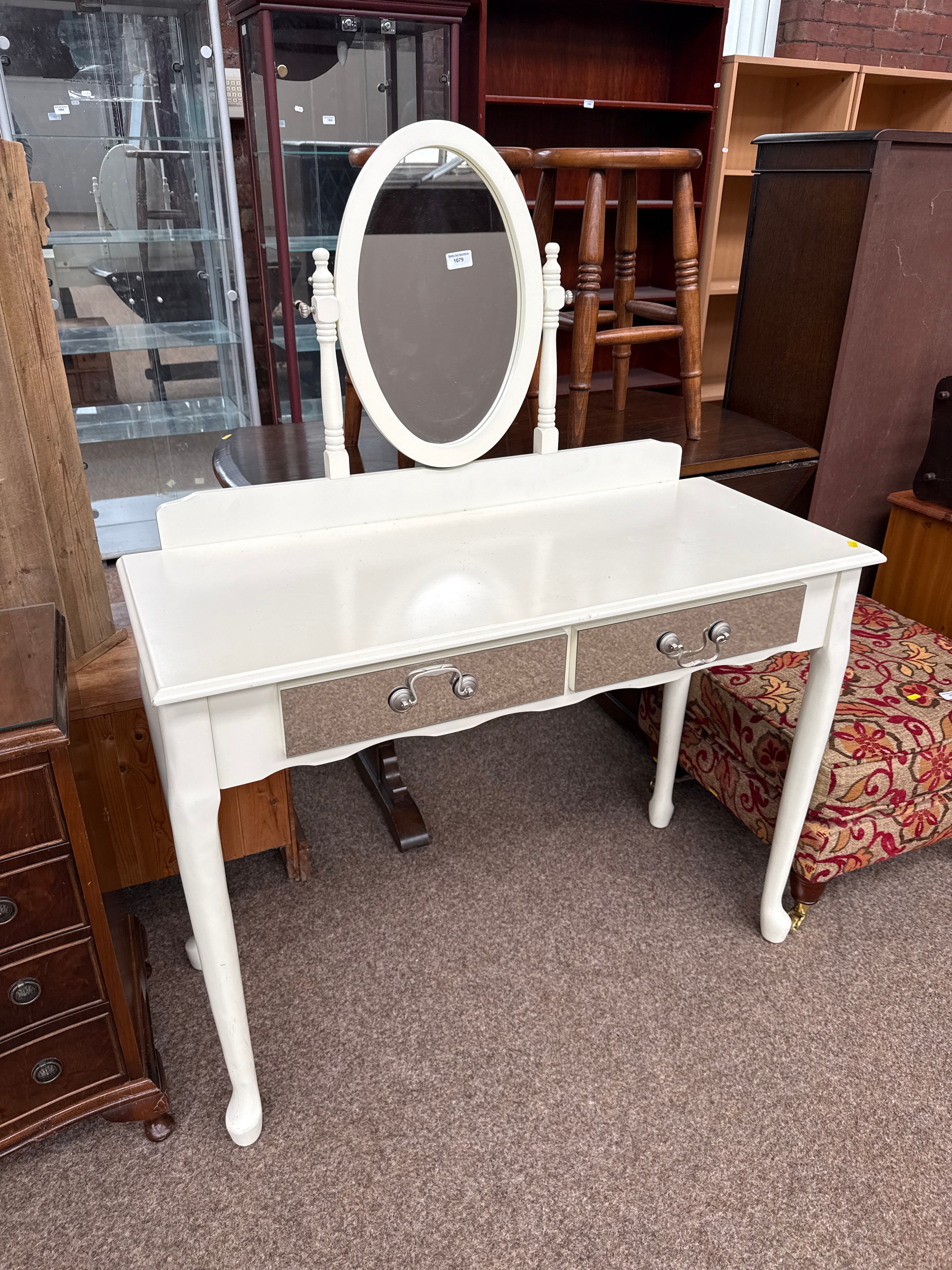 A painted vintage dressing table with mirrored drawer fronts