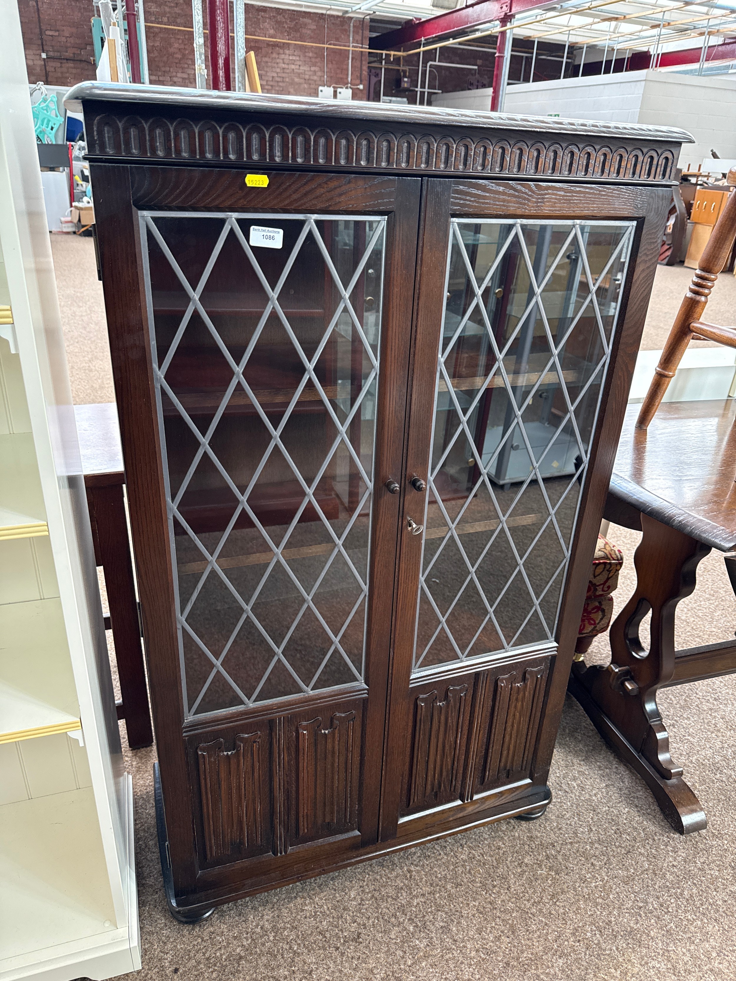 A large vintage 2 door lead glazed linenfold cabinet