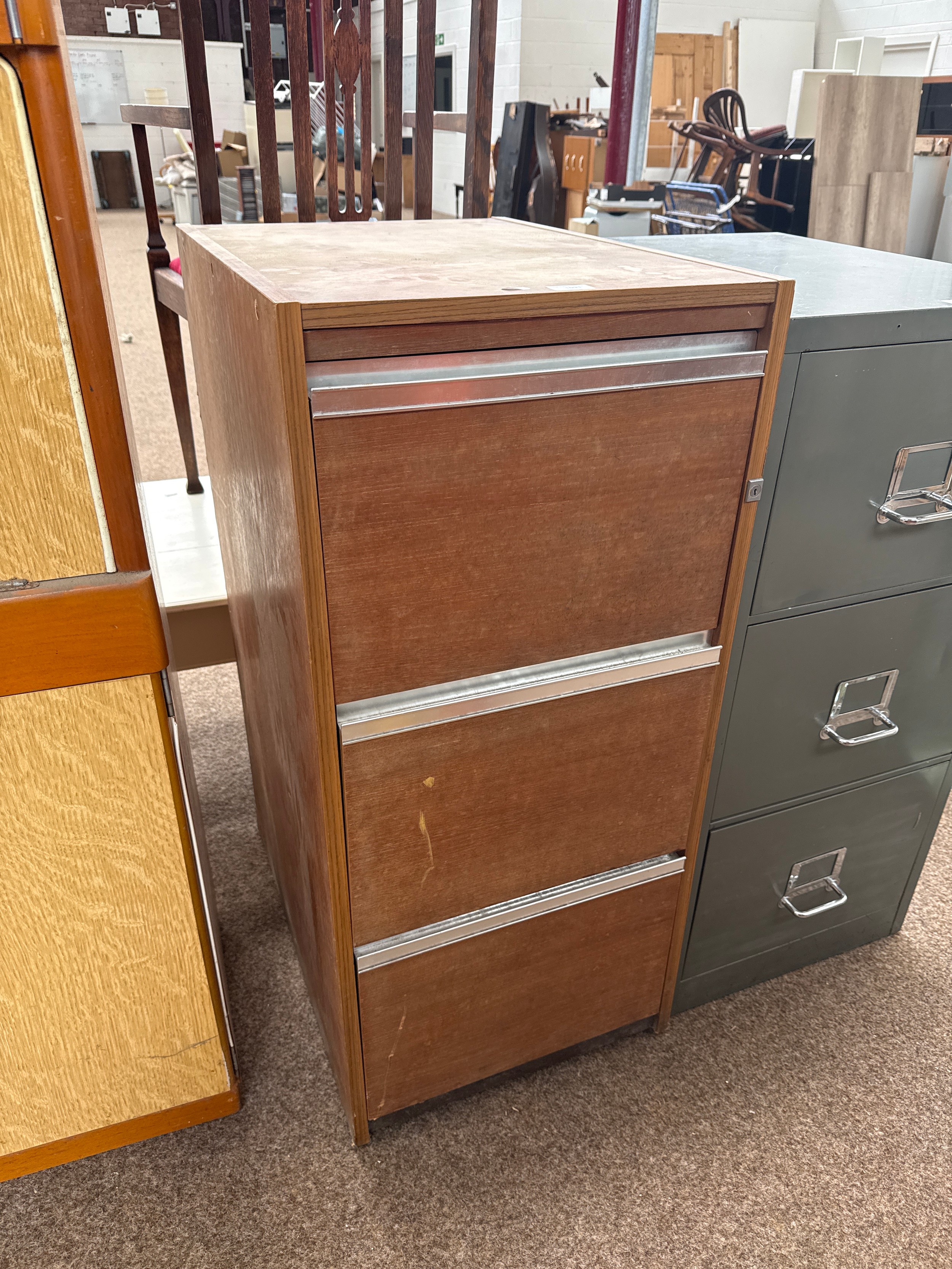 A vintage 3 drawer wooden filing cabinet