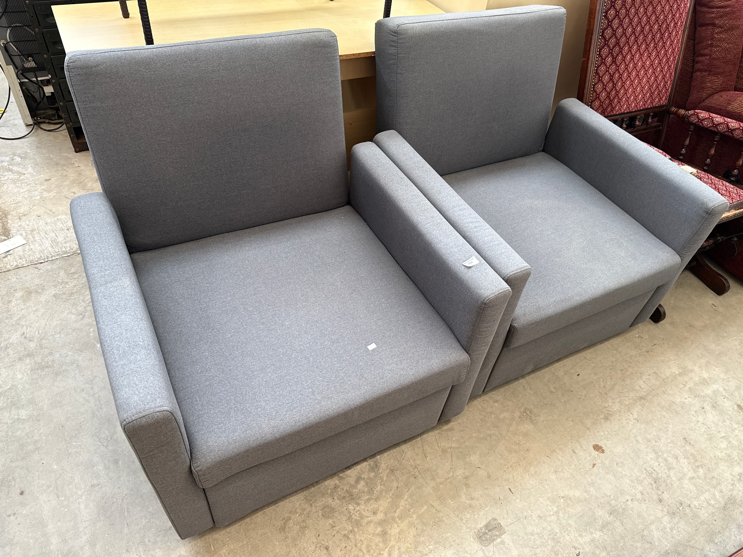 A pair of upholstered club style armchairs