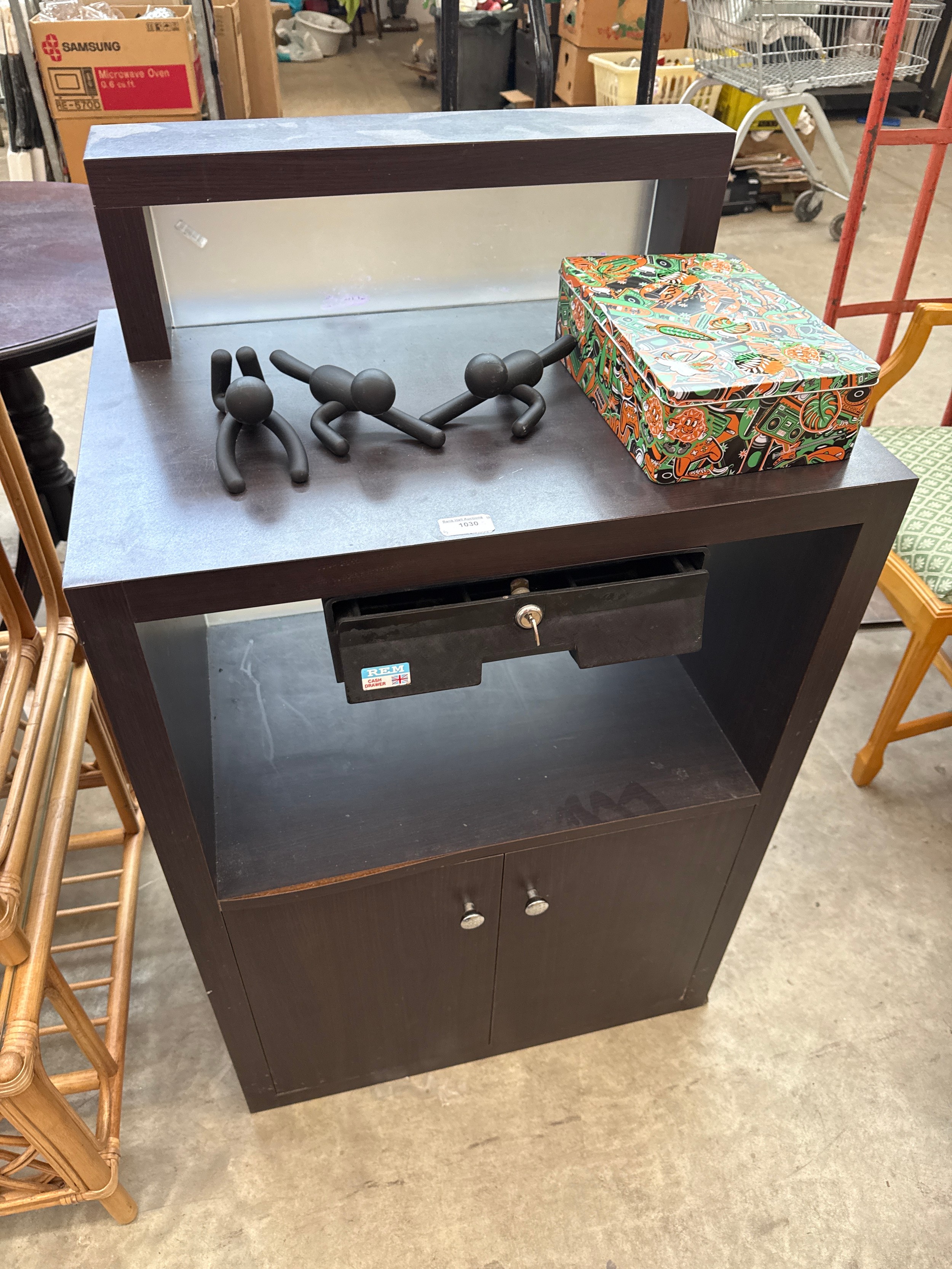 A small retail counter stand unit with lockable cash drawer