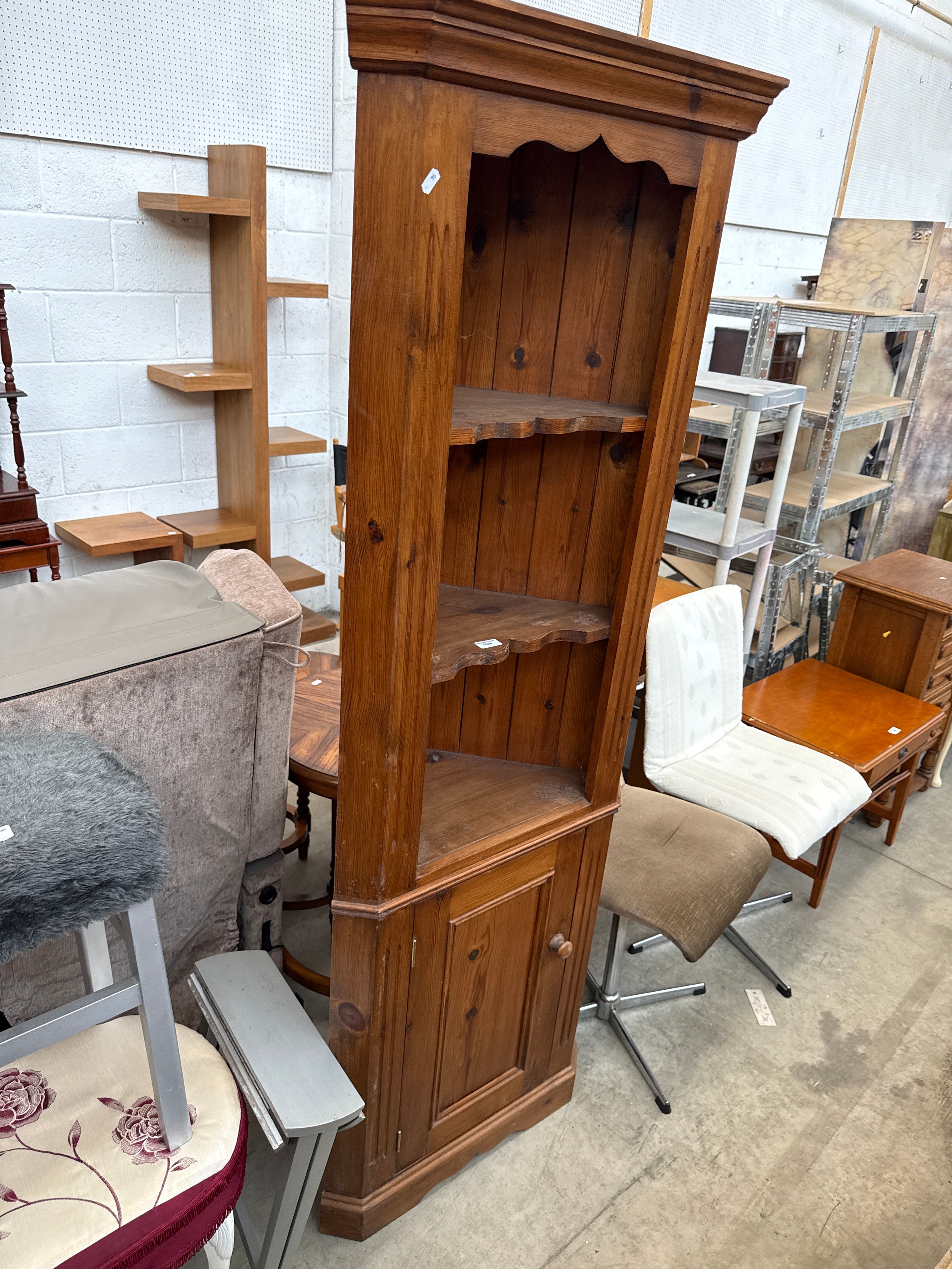 A vintage pine corner cabinet with cupboard