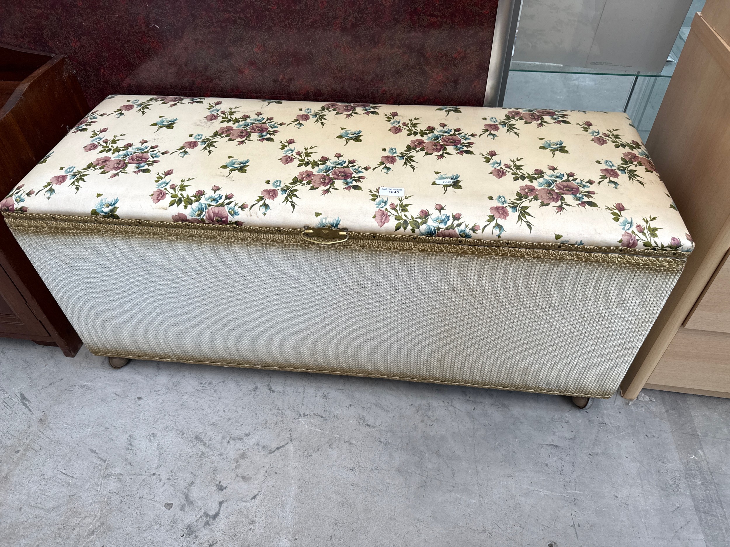 A vintage blanket box with upholstered seat top