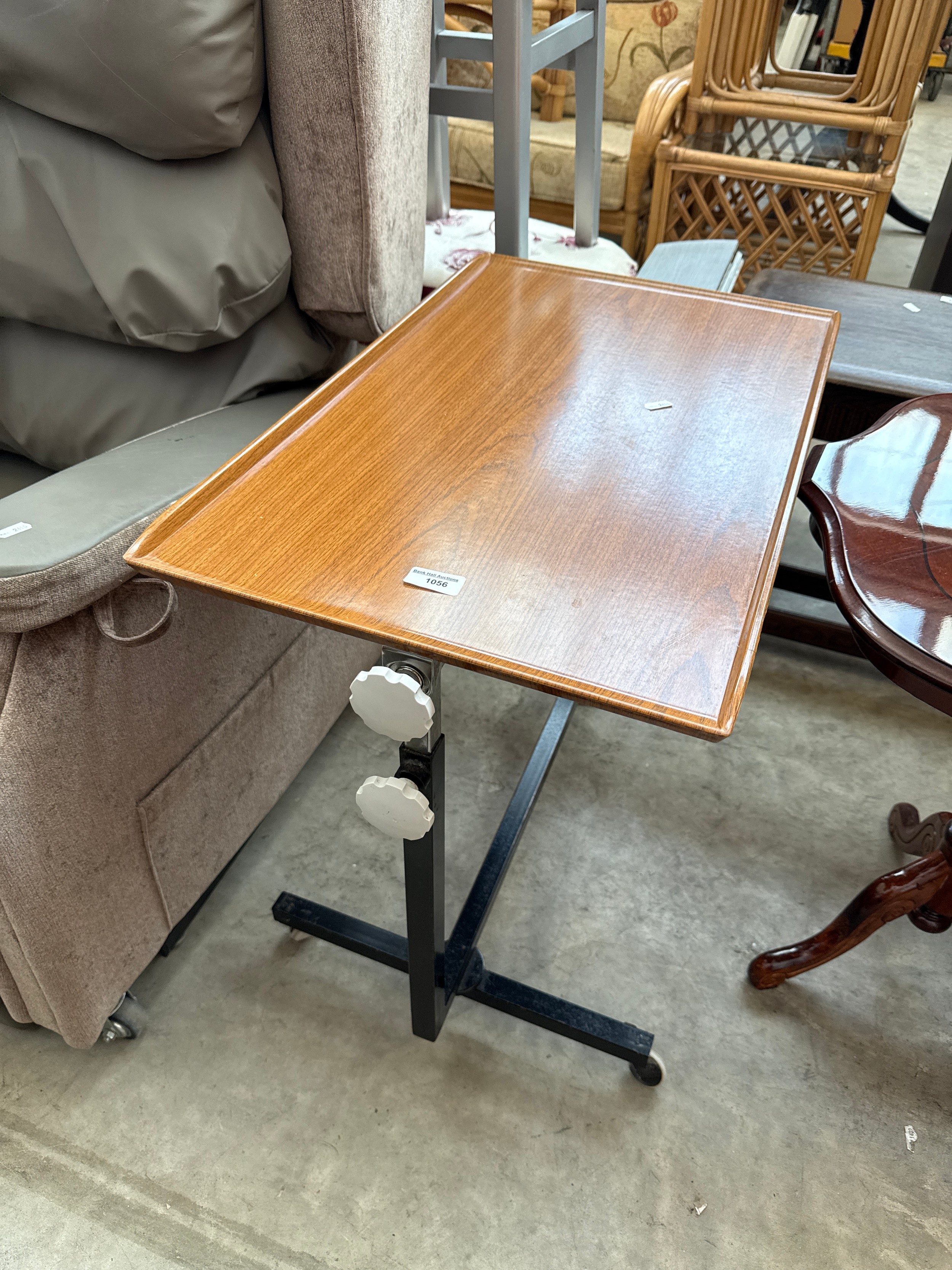 An adjustable over bed/chair table trolley
