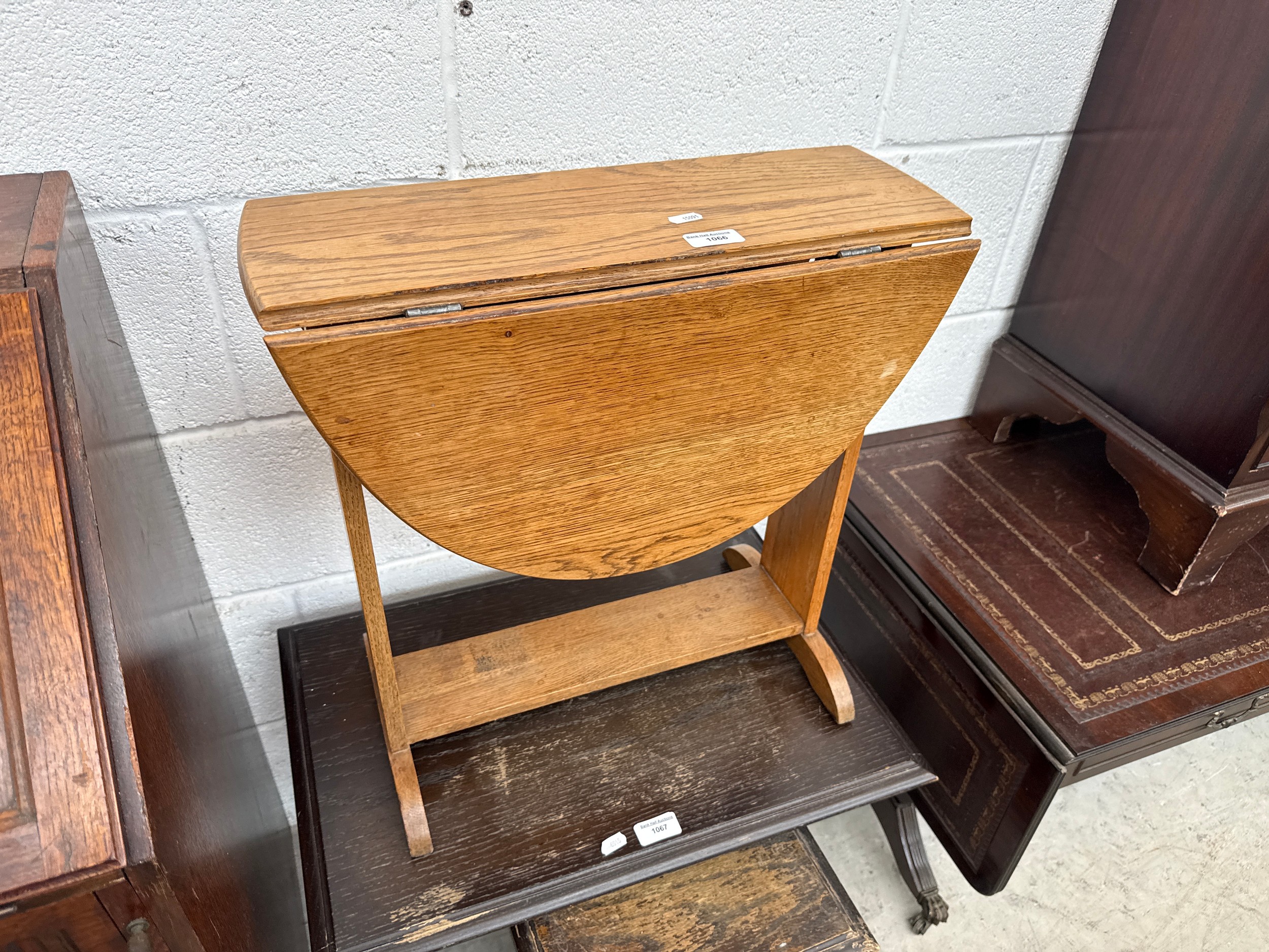 A small vintage light oak swivel top occasional table