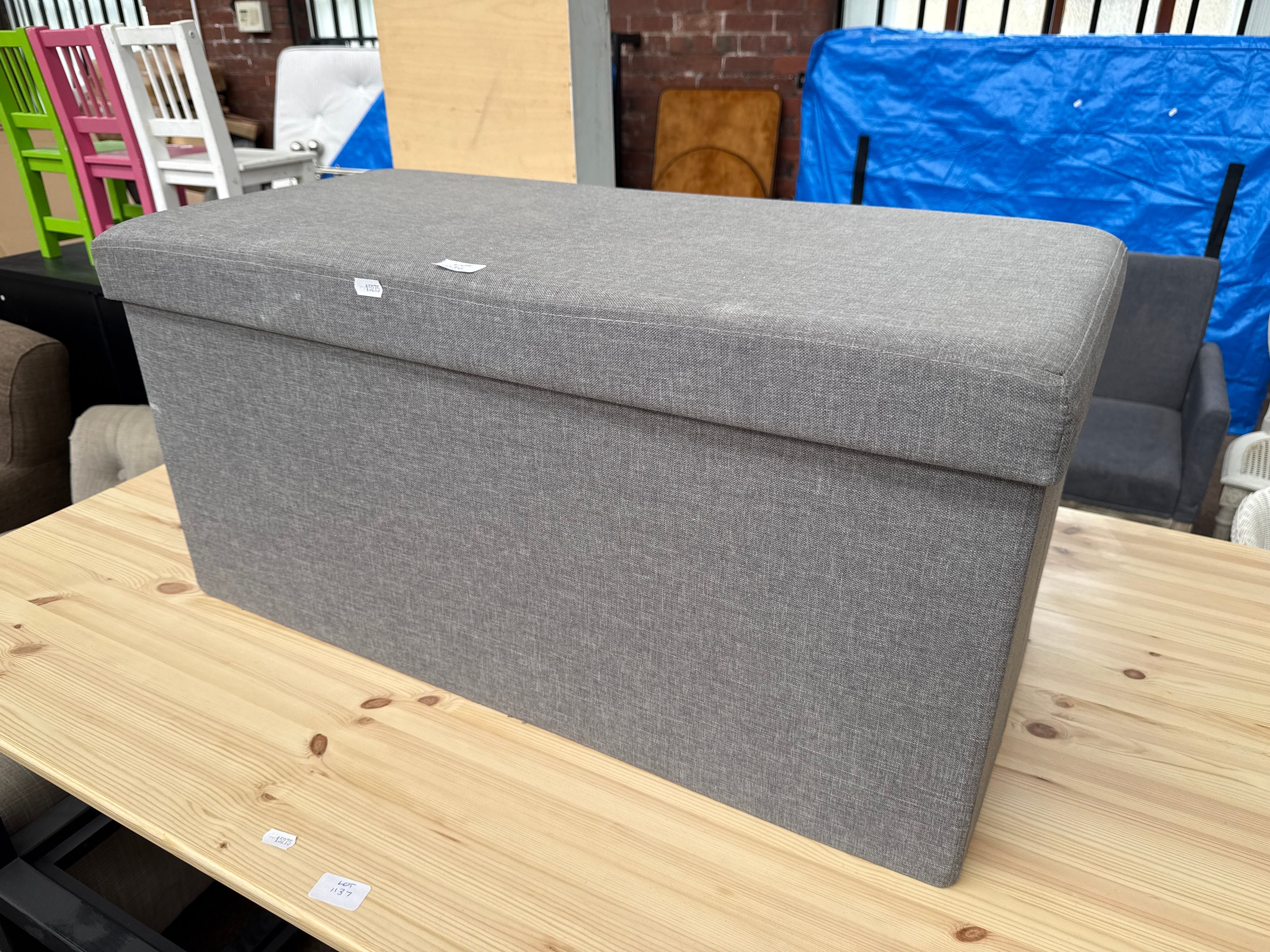 A fabric covered Ottoman storage seat, as new, never used
