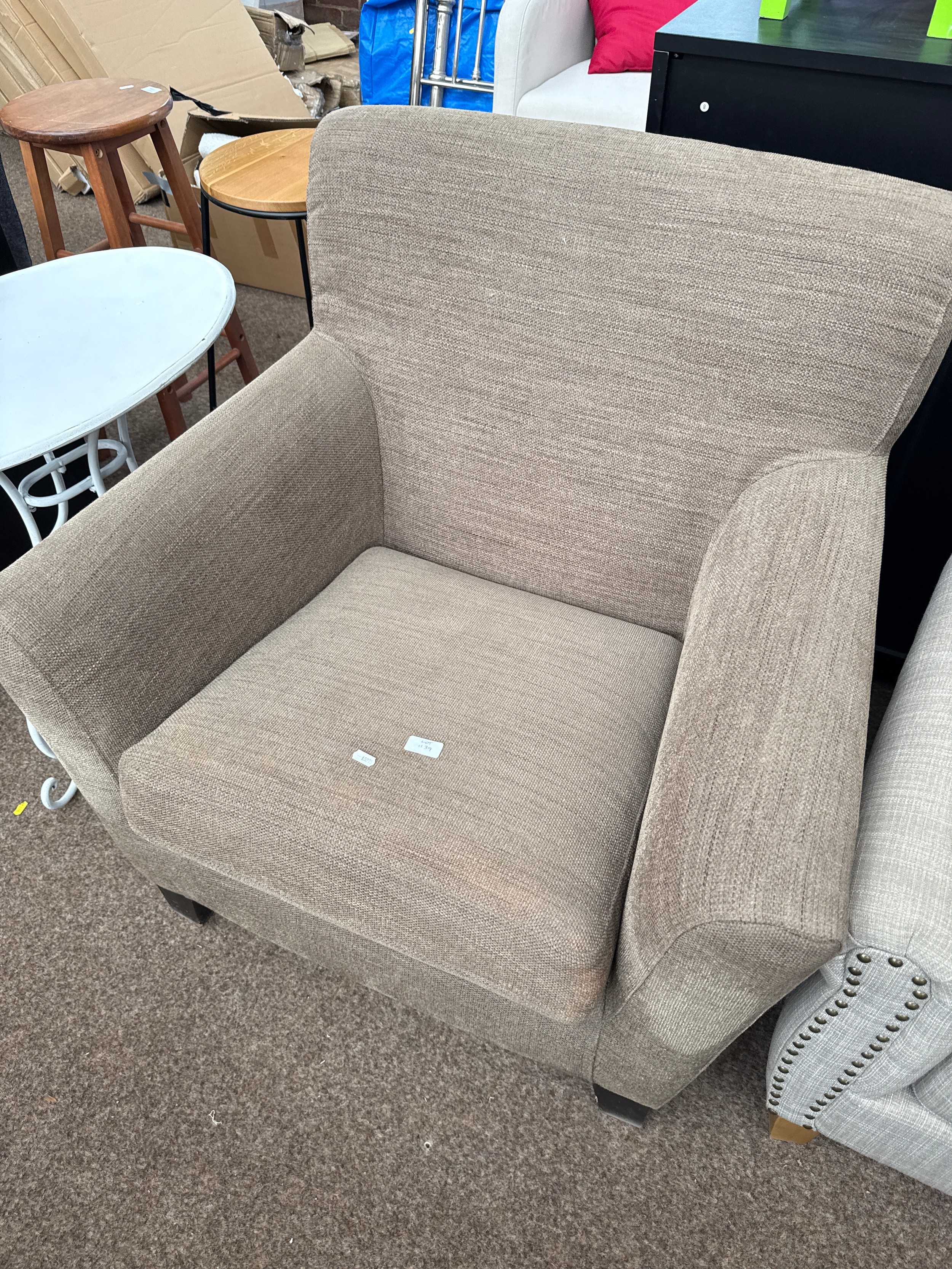 An upholstered armchair, as new, never used