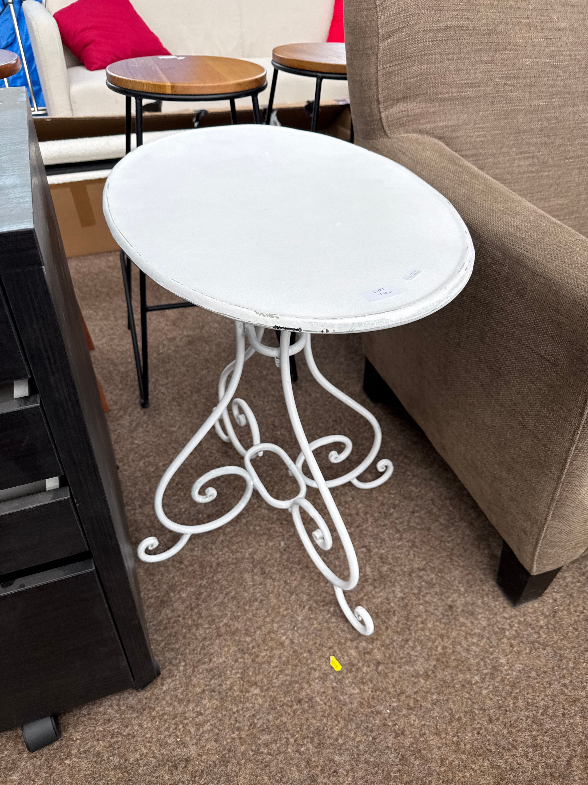 A painted metal oval garden table